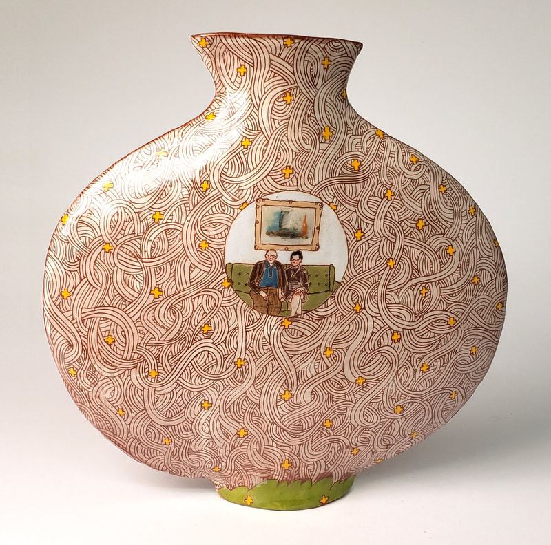 a terra cotta vase with sgraffito decoration and image of couple on a chesterfield. 